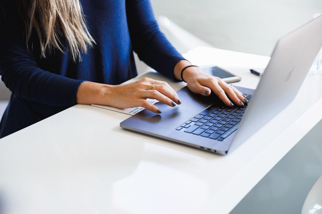 mystery author typing on laptop